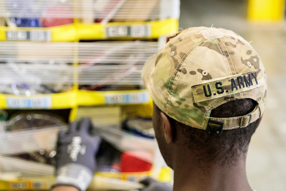 Employee with U.S. army hat works on at customer package
