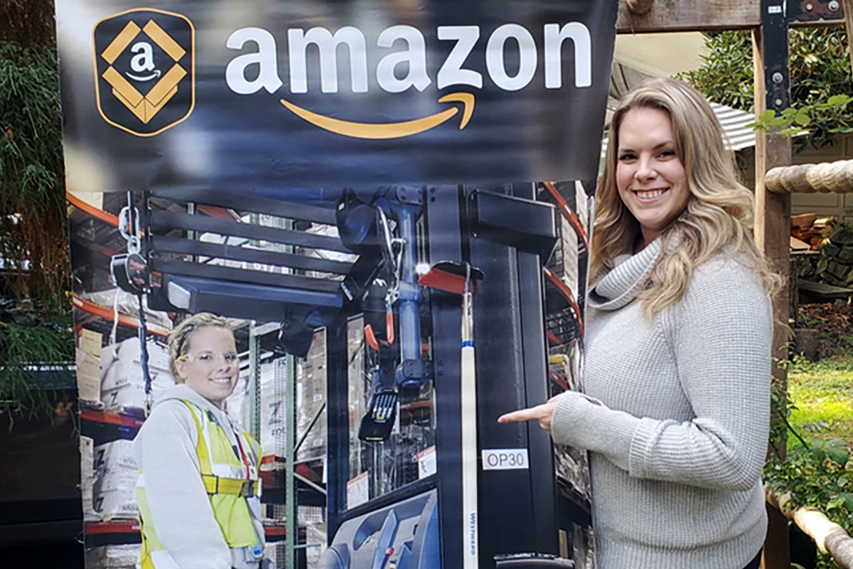 Amazon recruiter points to an image of herself working in the fulfillment center
